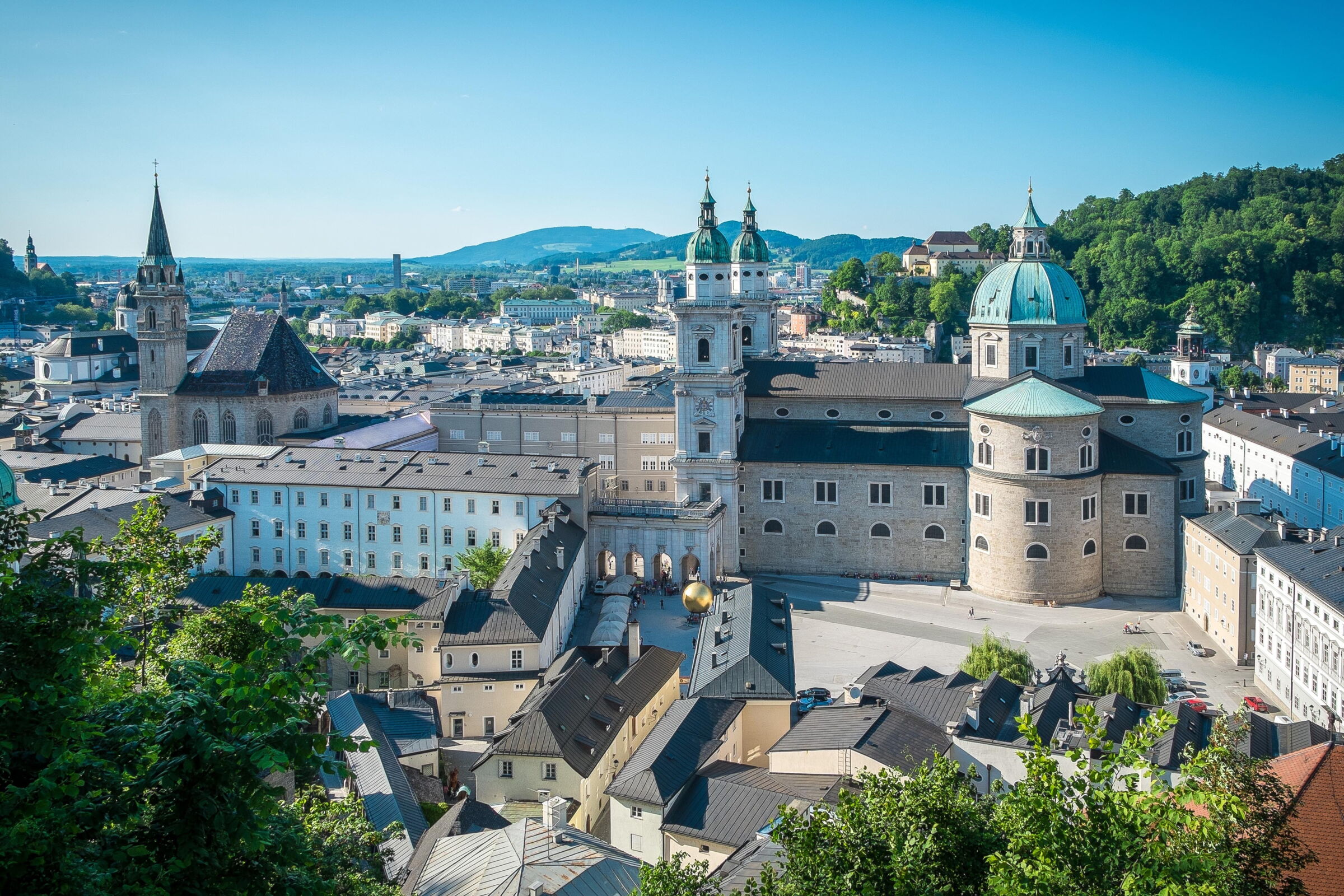 View of Salzburg's historic buildings and picturesque hills in the background.