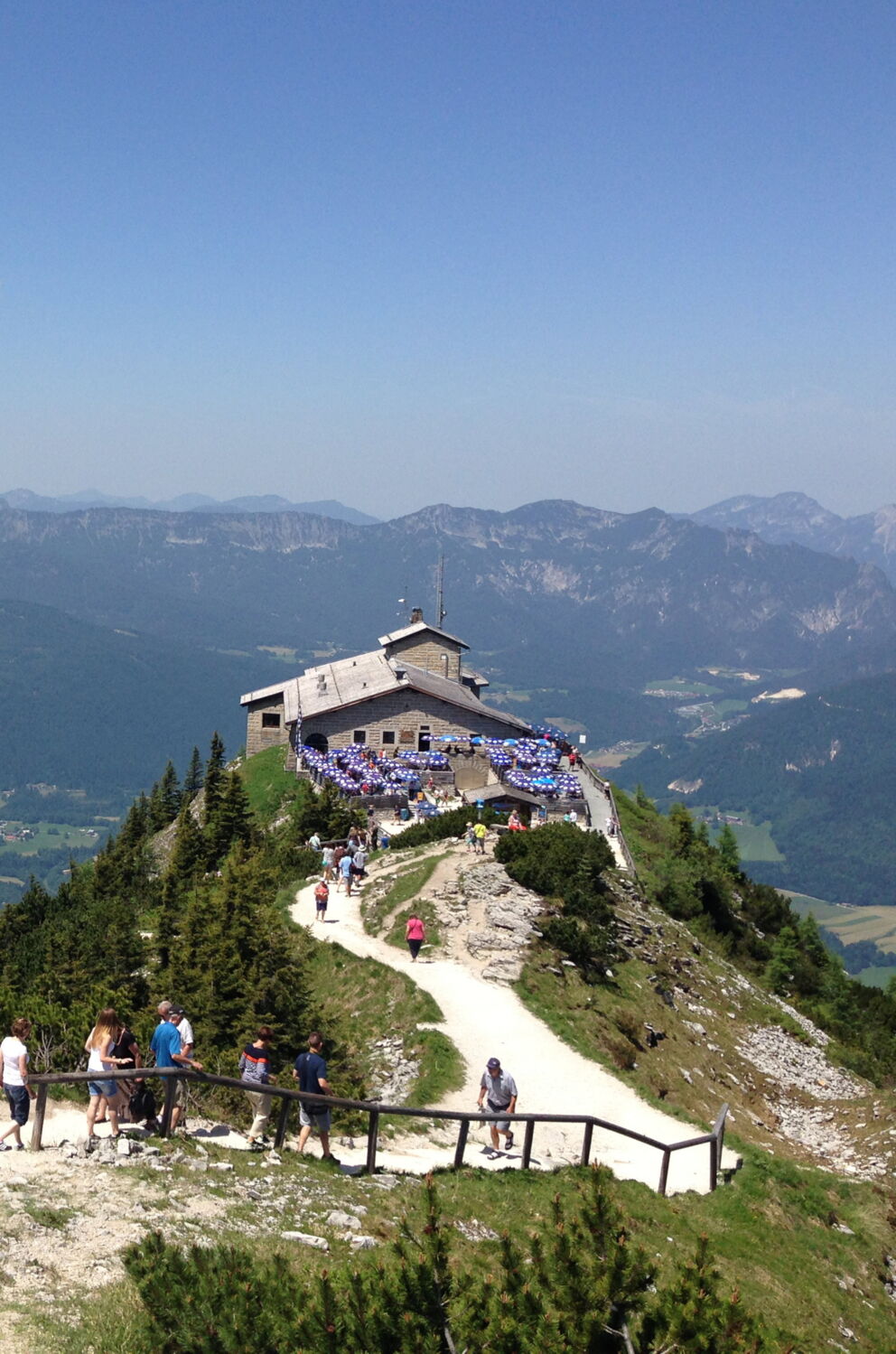 Visitors enjoy the panoramic view from a mountain peak in the Alps.