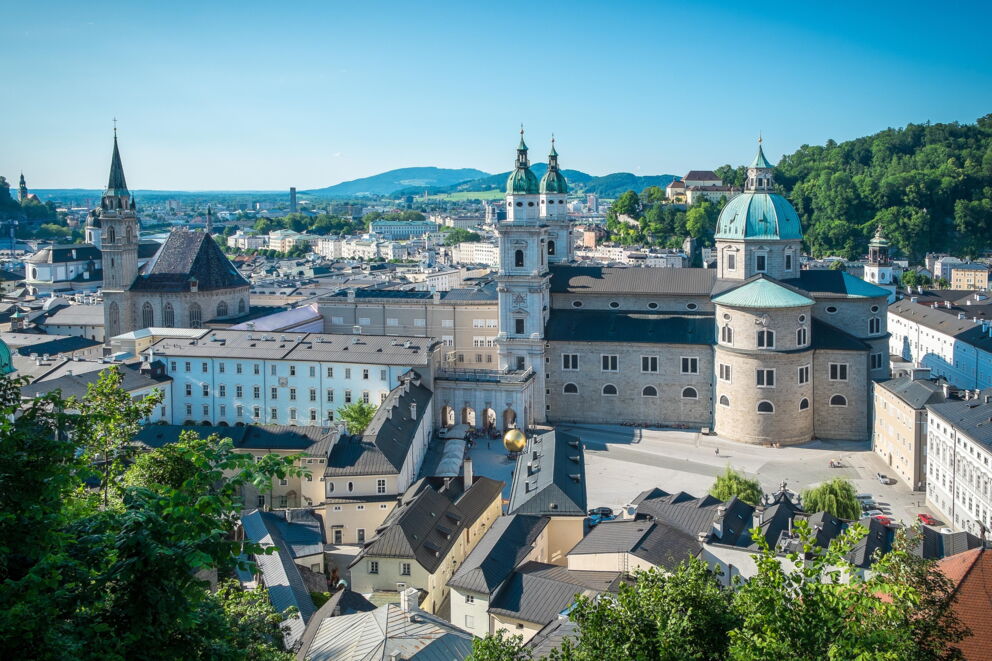 View of Salzburg's historic buildings and picturesque hills in the background.