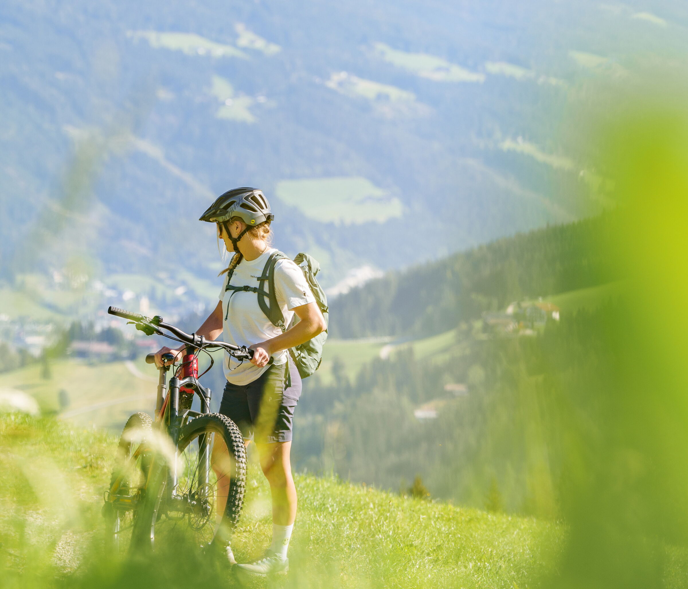 Einen Person die ihr Fahrrad hält und auf einer Wiese steht ©Salzburgerland Tourismus Foto: Gerald Oberreiter