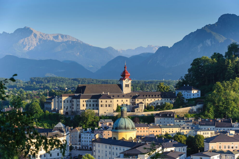 City view of Salzburg with mountains in the background, historical buildings in focus.