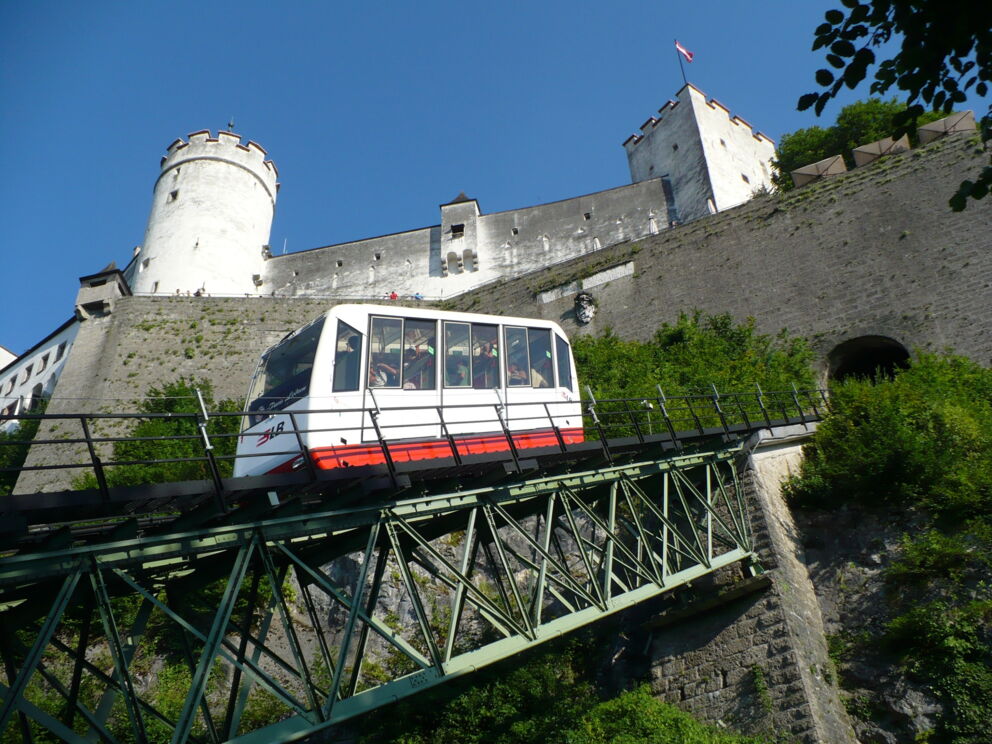 Cable car ride to the historic fortress in Salzburg on a clear day.